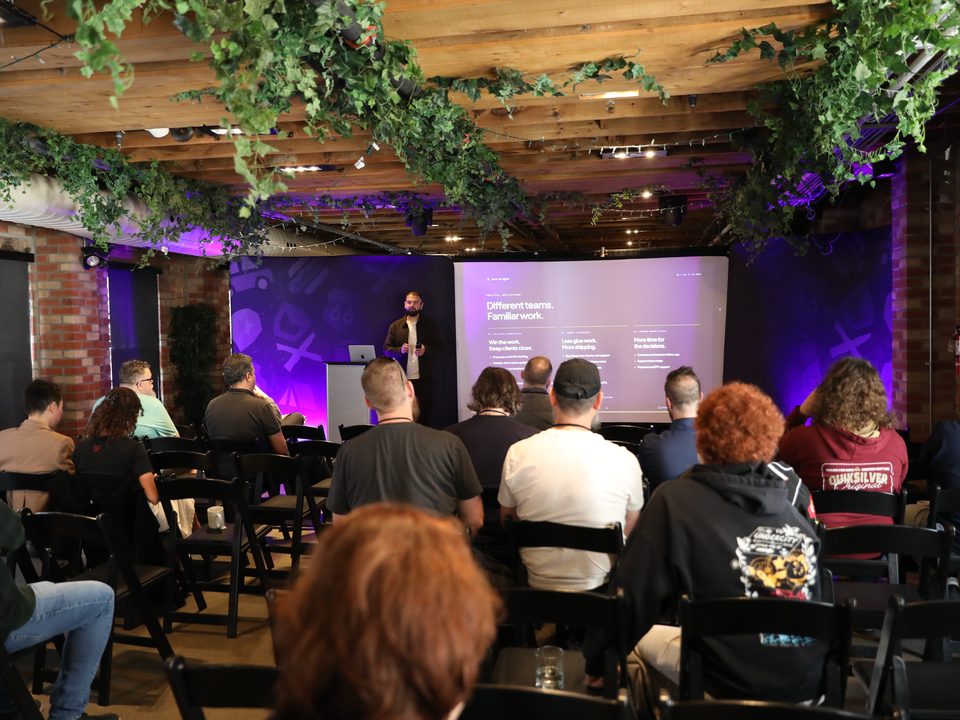 A Zero to Agent talk on a purple-lit stage, seen from the back of a full room.