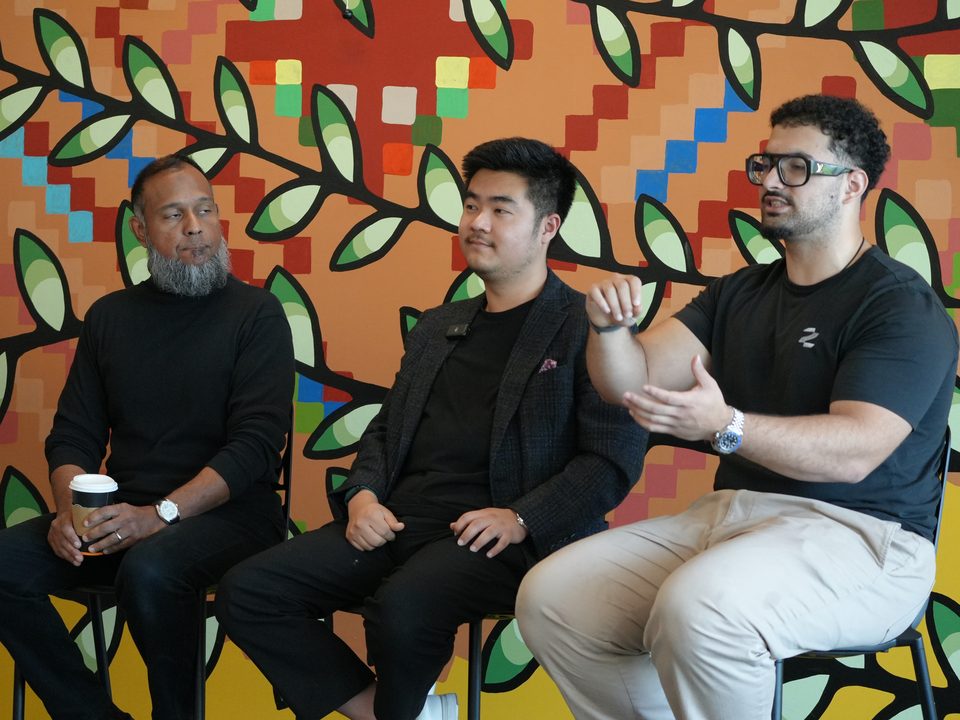 Three people on a panel in front of a bright mural, two of them from Zero to Agent.